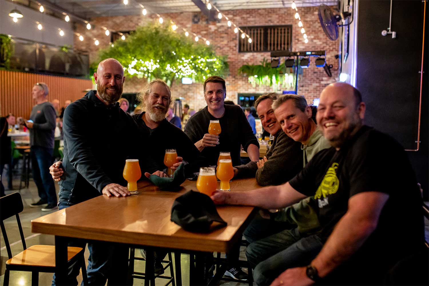 Group of men having a beer together at a brewery